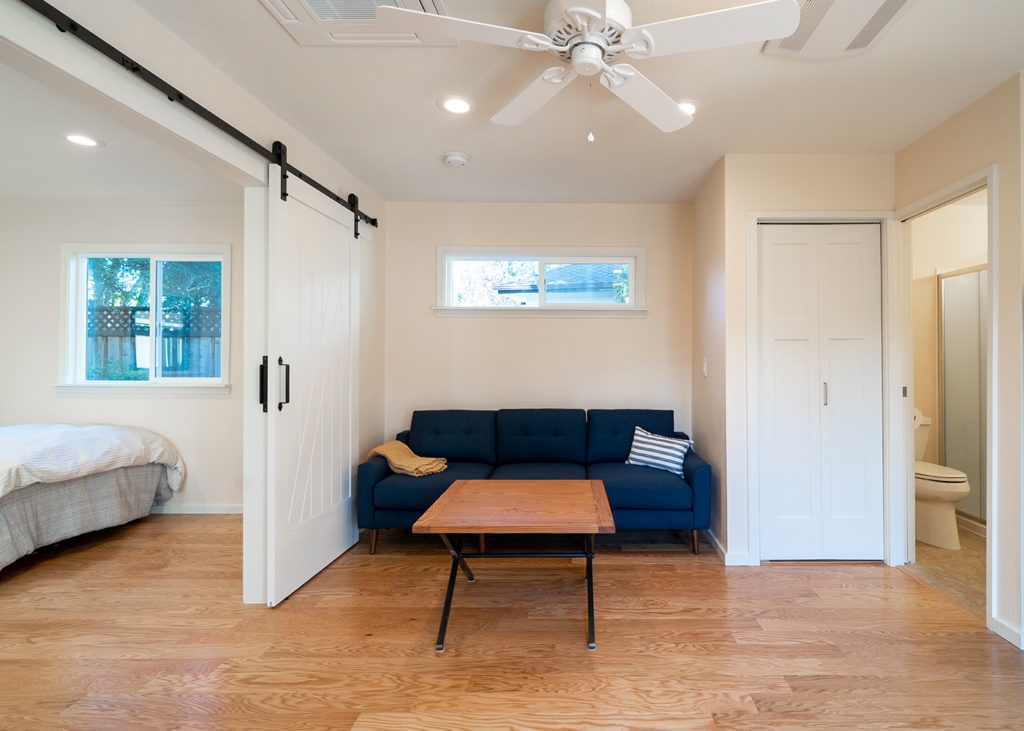 Studio Interior with Navy Blue Sofa and Sliding Barn Door