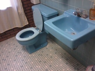 Toilet in Powder Blue Porcelain with Retro Colorful Mosaic Tile Floor
