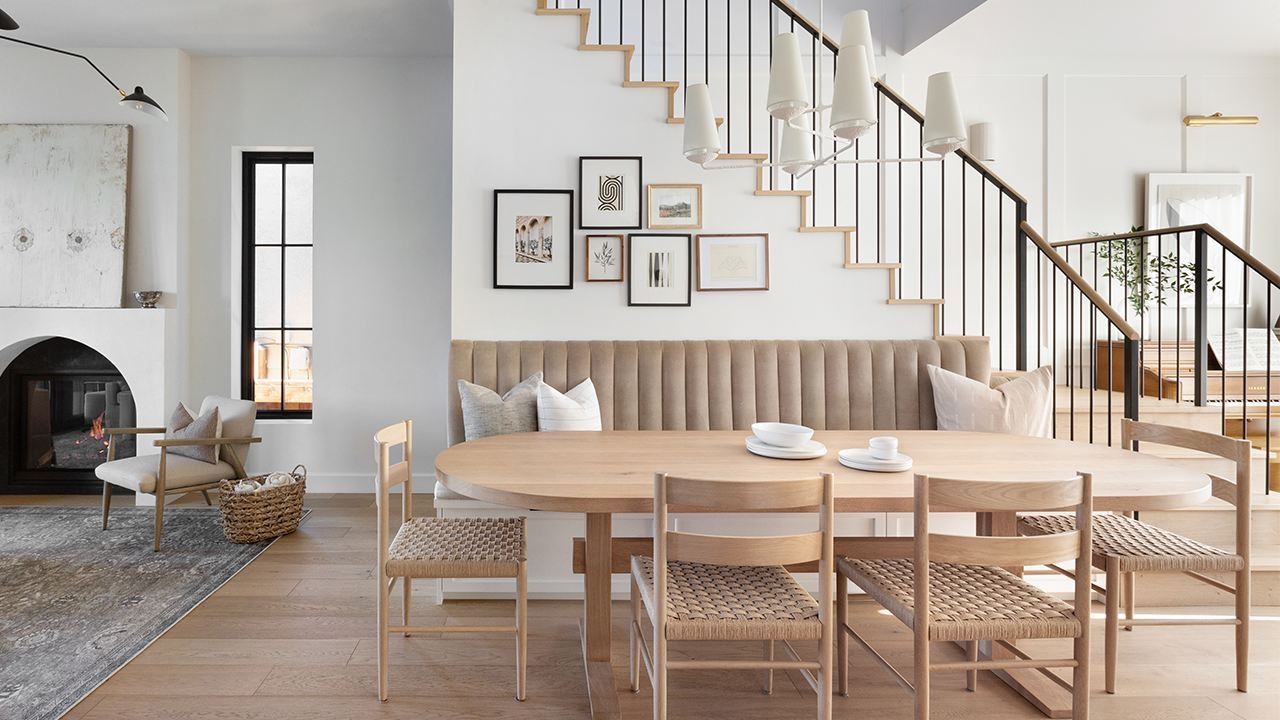 Under-Stair Banquette Seating with Oval Wood Table and Woven Seat Chairs
