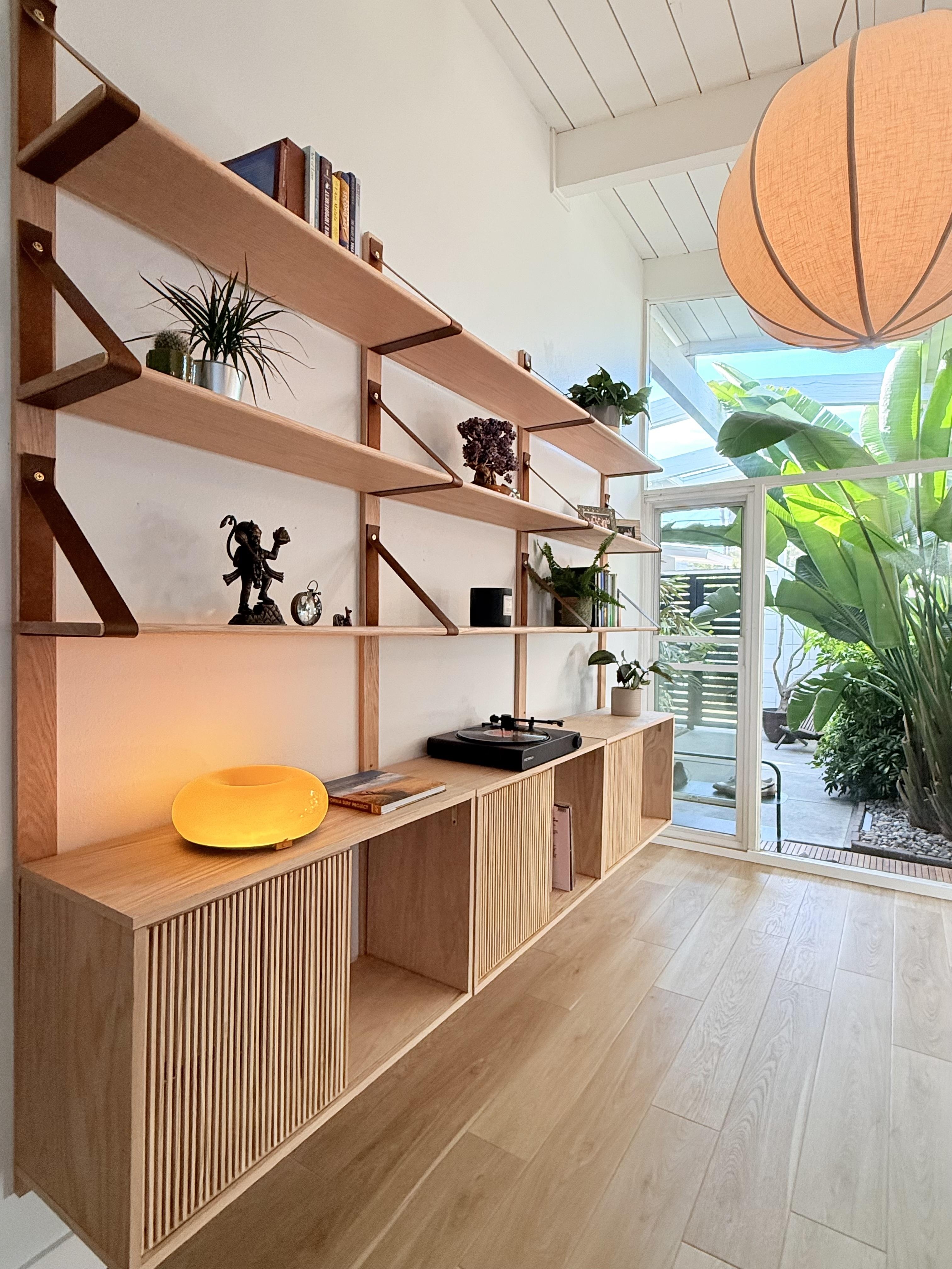 Wall Shelving System: Leather Strap Supports Wall Shelves