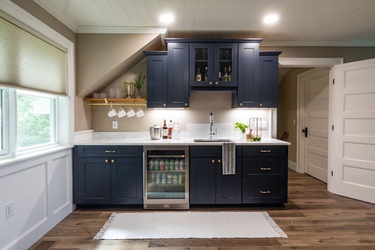 Wet Bar featuring Navy Shaker Fronts and Sloped Wall Integration