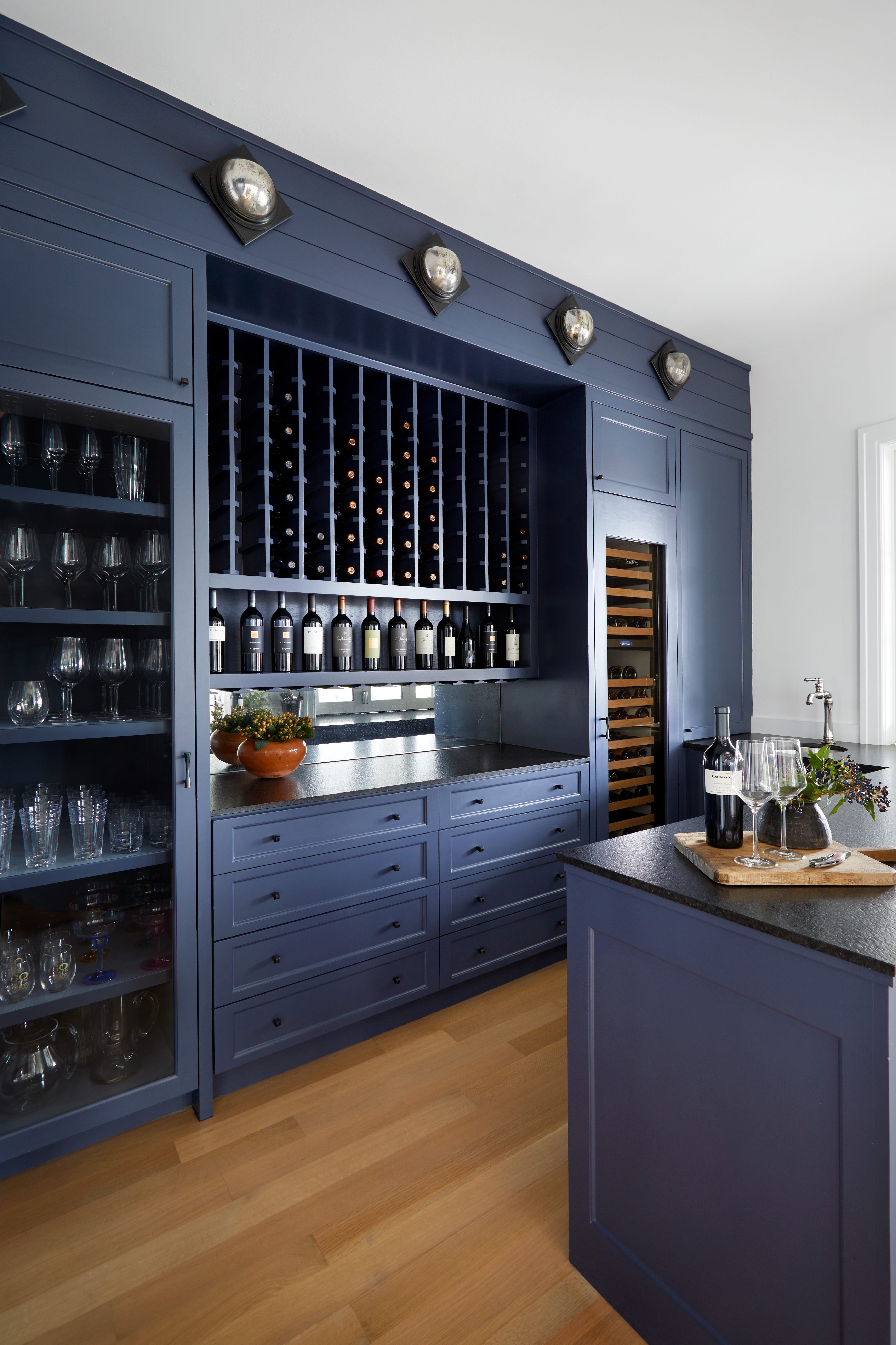 Wet Bar including Navy Blue Cabinets and Vertical Wine Cubbies