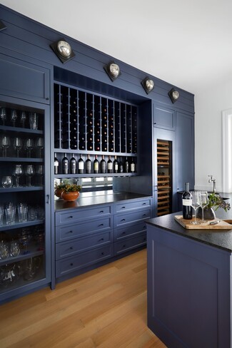 Wet Bar including Navy Blue Cabinets and Vertical Wine Cubbies