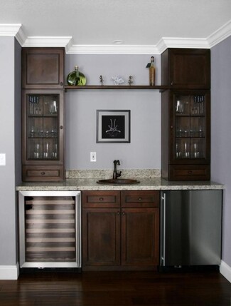Wet Bar with Copper Toned Sink and Symmetrical Cabinets
