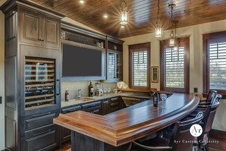 Wet Bar with Curved Wood Counter and Lantern Pendants