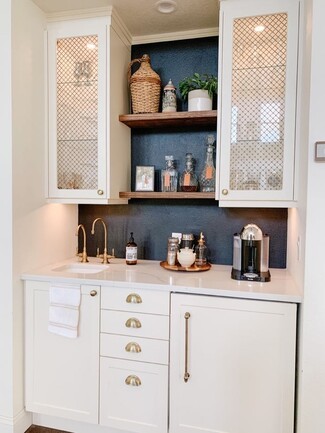 Wet Bar with Mesh Cabinet Doors and Black Backsplash