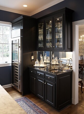 Wet Bar with Mirrored Backsplash and Matte Black Cabinets
