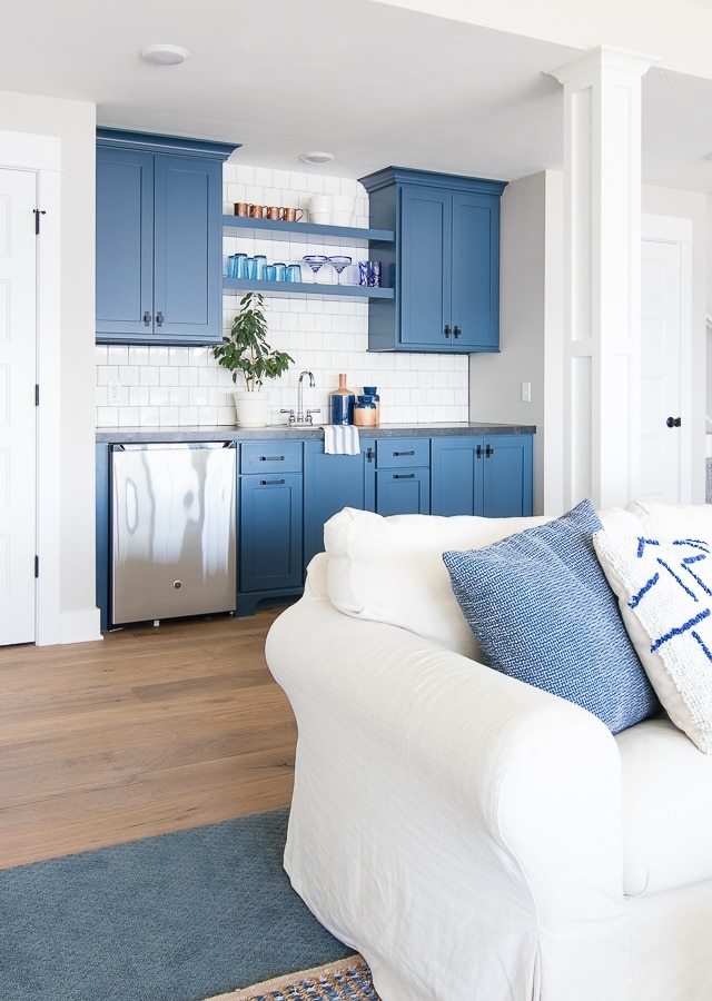 Wet Bar with Open Blue Shelving and White Subway Tile