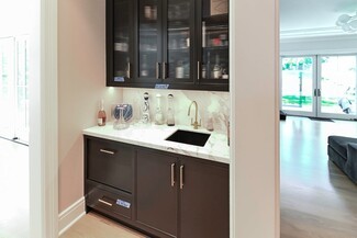 Wet Bar with Reeded Glass Cabinets and Gold Hardware