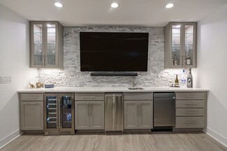 Wet Bar with Stacked Stone Backsplash and Mounted TV