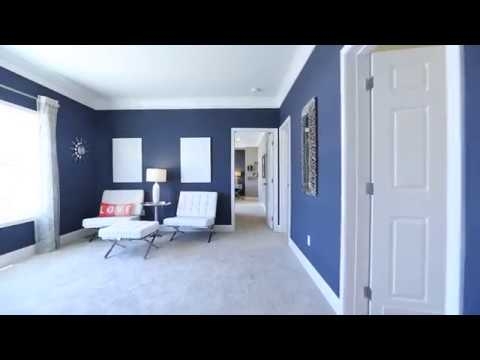 Accent Chair with Navy Blue Walls and High Contrast Decor