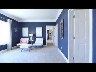 Accent Chair with Navy Blue Walls and High Contrast Decor