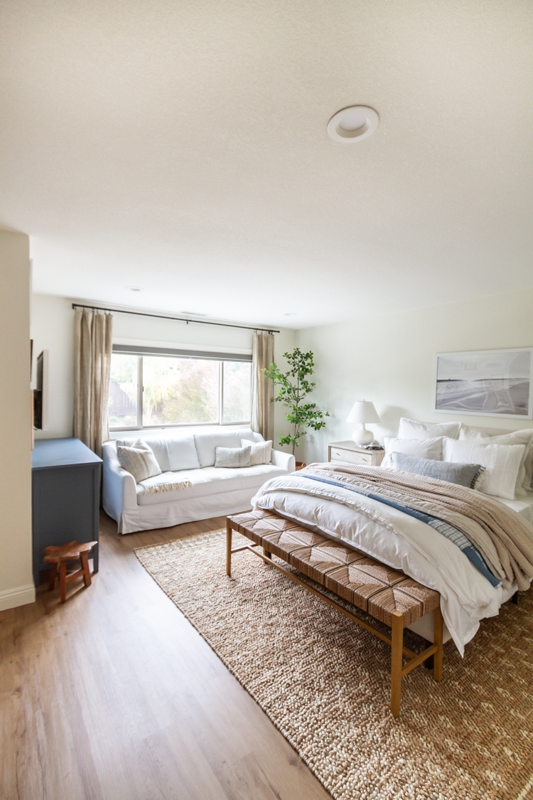 Bedroom featuring Slipcovered Window Seating and Textured Jute Rug