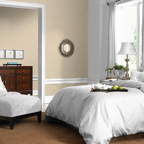 Bedroom Interior featuring Wheat Walls and Starburst Mirror