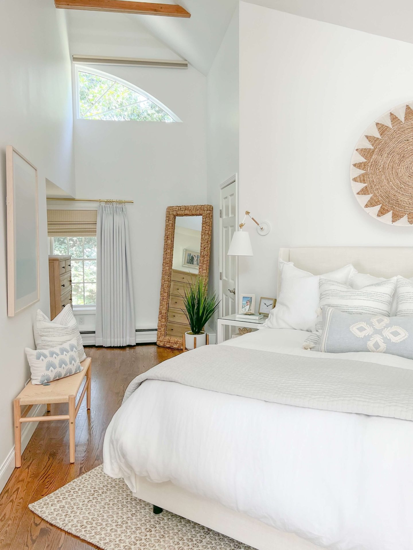 Bedroom Interior with Architectural Windows and Woven Floor Mirror