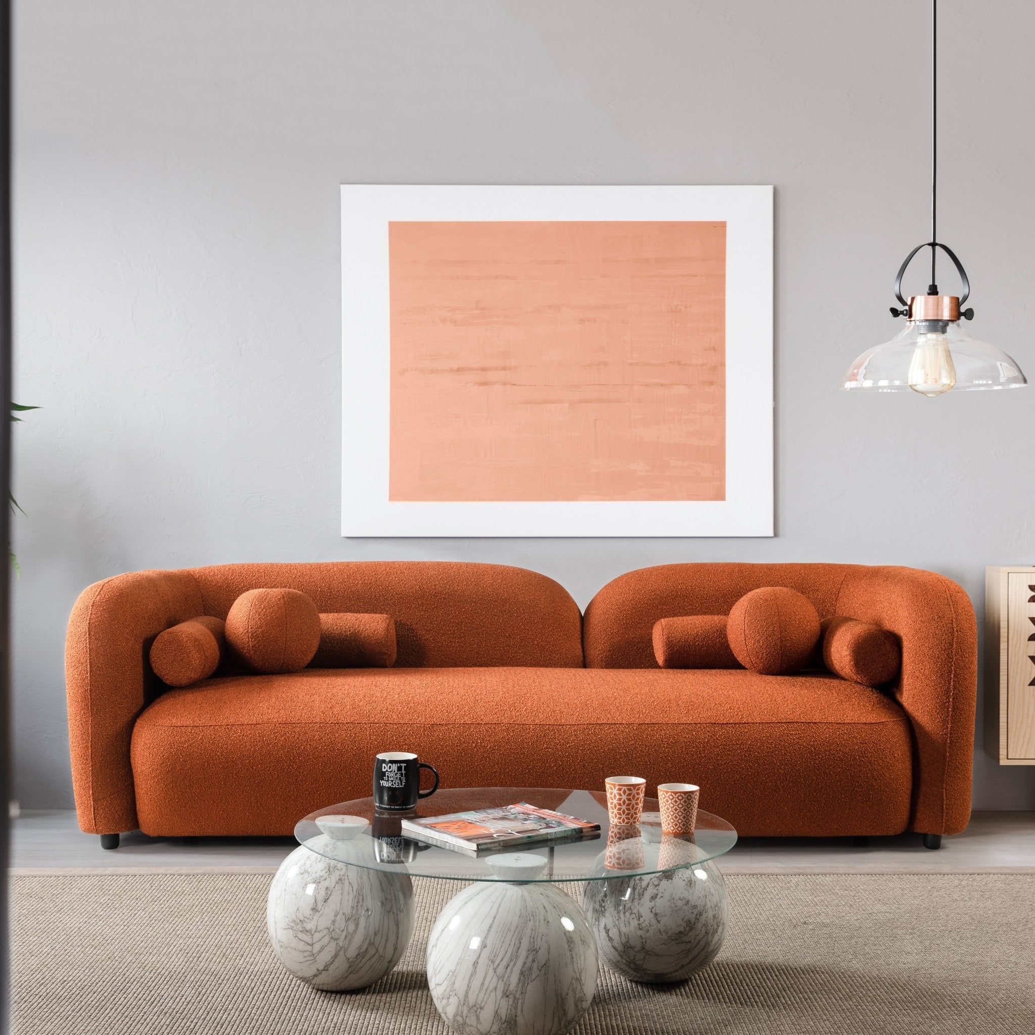 Curved Sofa with Marble Globe Base and Sphere Pillows