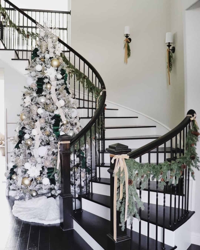 Curved Staircase Flocked Tree with Elegant Holiday Entryway Decor