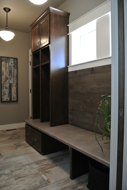 Entryway Lockers with Dark Wood Paneling and Built-in Bench