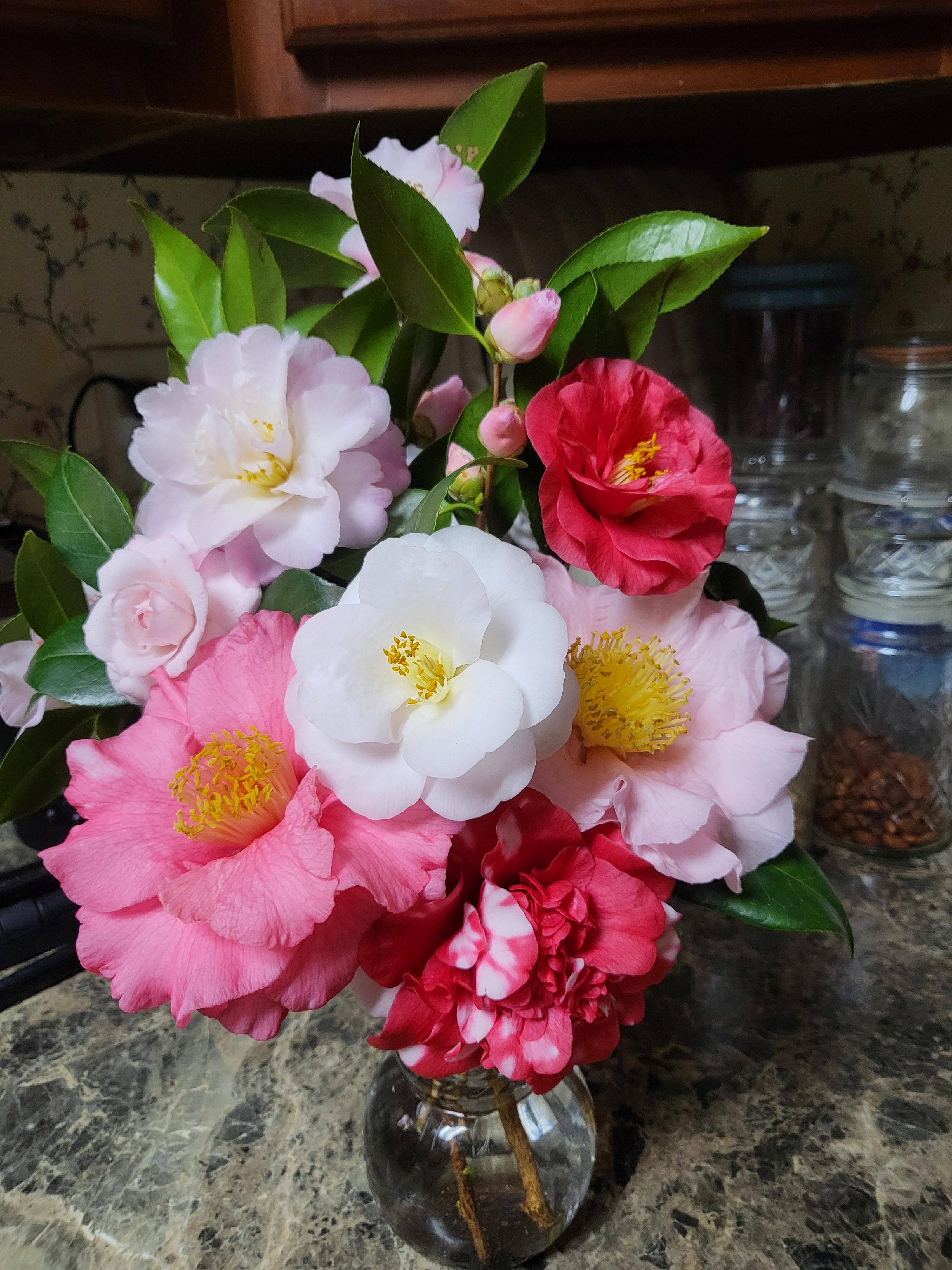 Floral Arrangement in Orb Glass Vase and Winter Camellia Centerpiece