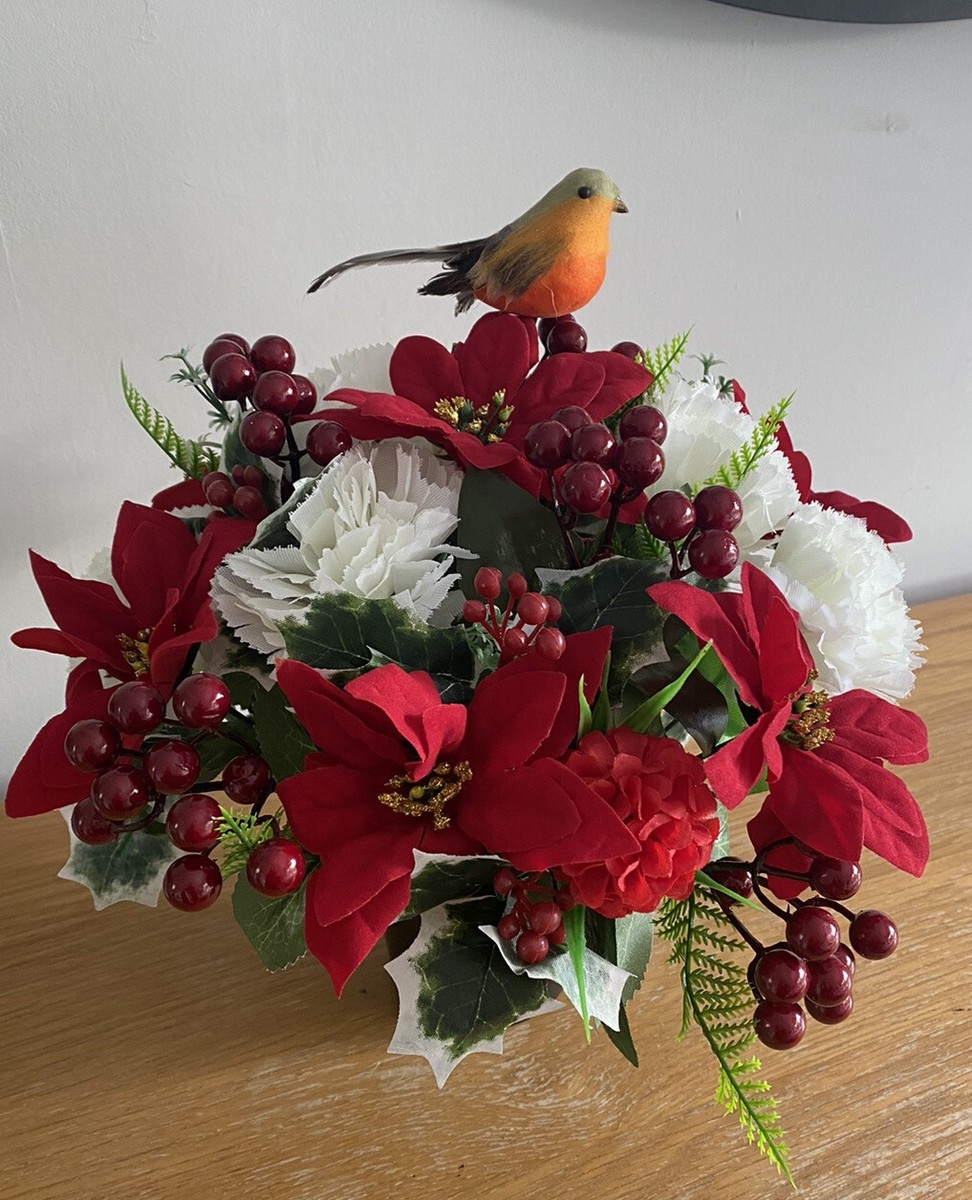Flower Arrangement: Poinsettia Blooms and Decorative Bird Accent