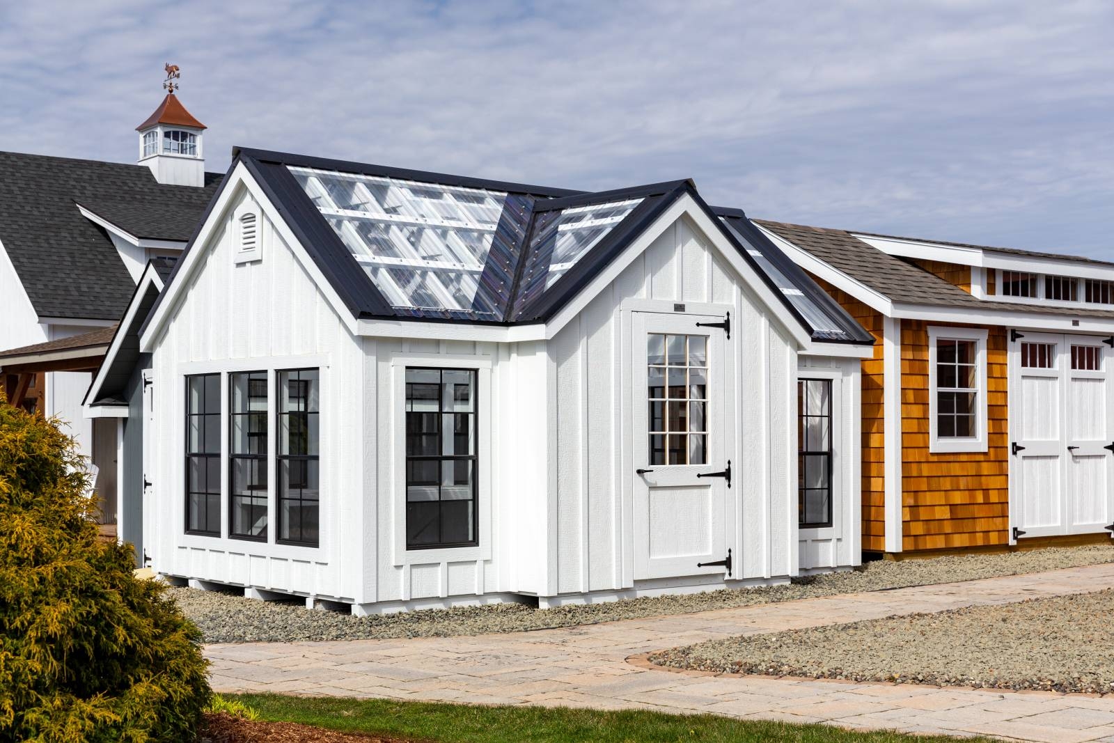 Greenhouse with Board and Batten Siding and Black Trim