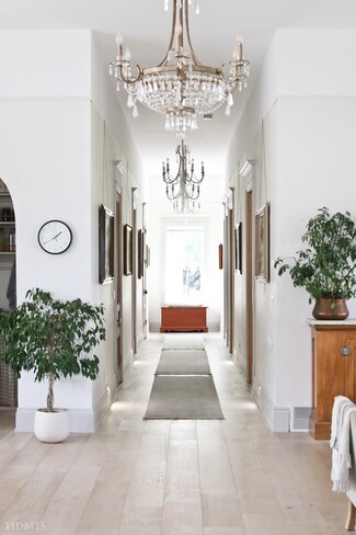 Hallway Crystal Chandeliers and Picture Rail Art Display