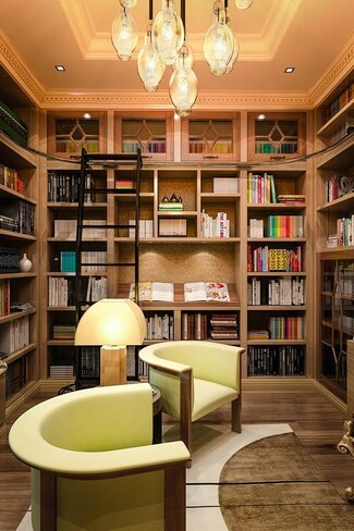 Home Library with Chartreuse Barrel Chairs and Rolling Ladder