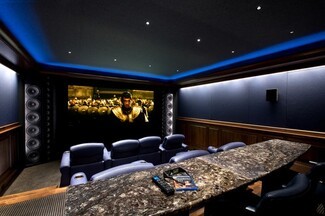 Home Theater: Luxury Home Theater Design and Veined Stone Counter