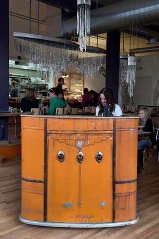 Host Stand Repurposed Vehicle Front with Distressed Orange Finish