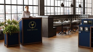 Hostess Station Navy Panels with Gold Logo Branding and Wood Trim