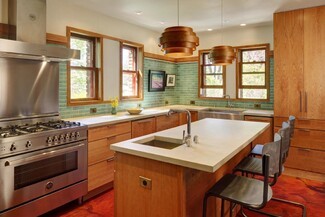 Kitchen Island Tiered Wood Pendants and Sage Green Subway Tile