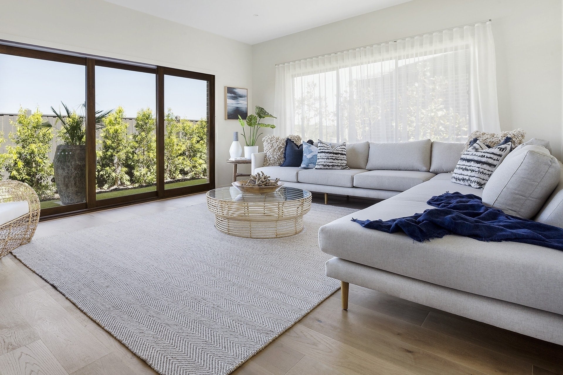 L-Shaped Sectional with Woven Rattan Base Navy Blue Accents