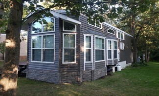 Mobile Home with Faux Stone Skirting and Tiny House Exterior