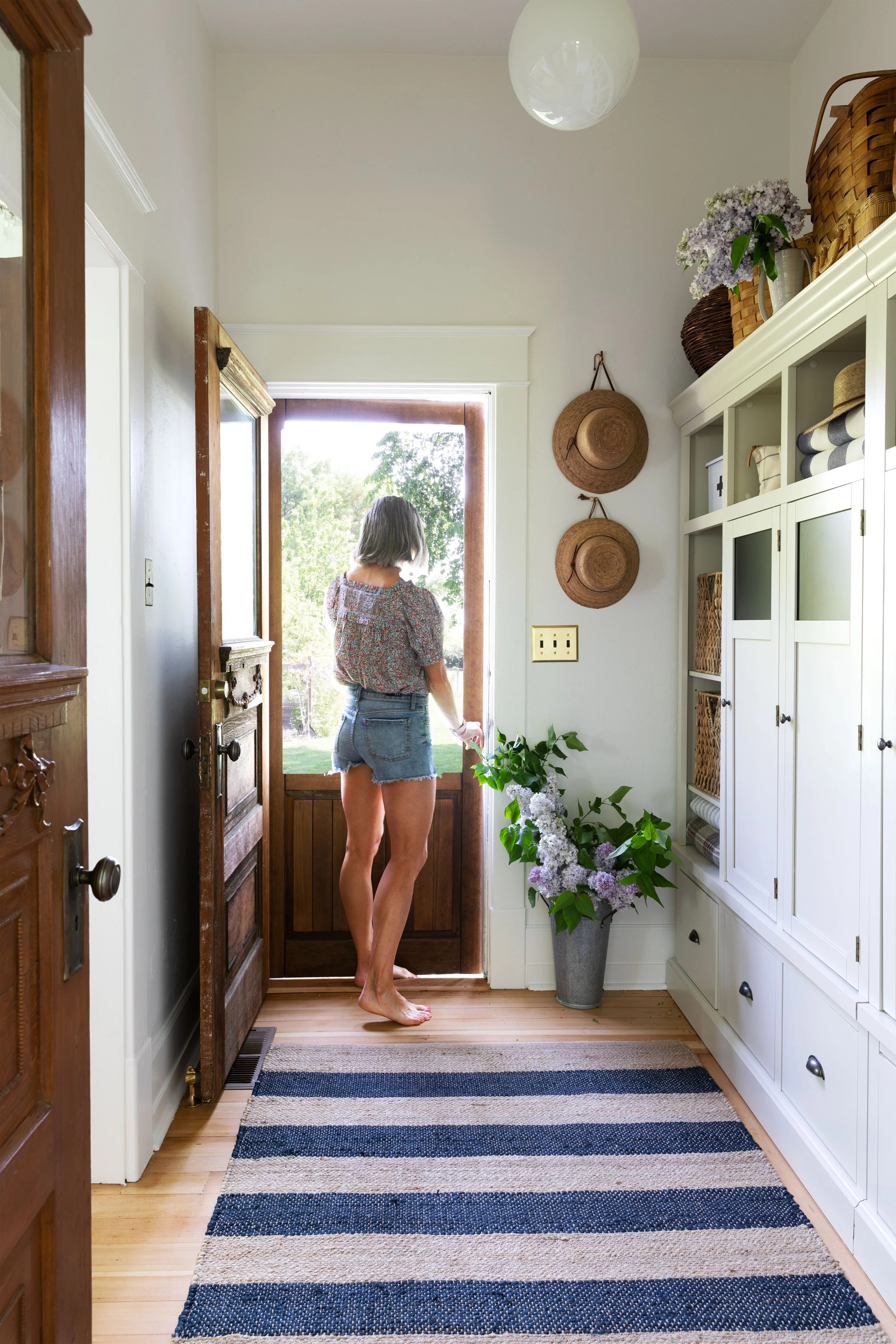 Mudroom Cabinetry: Striped Entryway Rug, Glass Front Cabinets