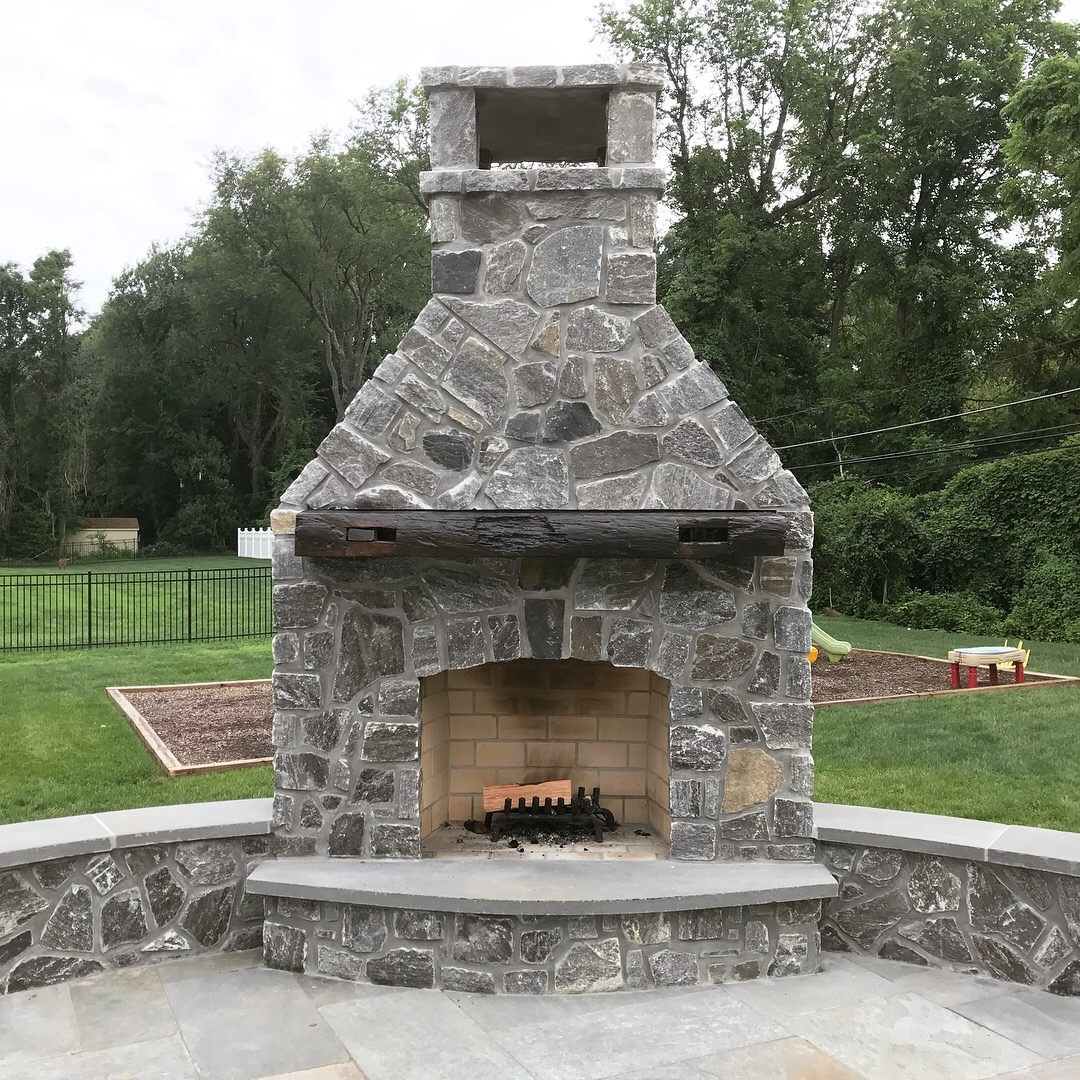 Outdoor Fireplace: Seating Wall Heavy Timber Mantel Stone Design