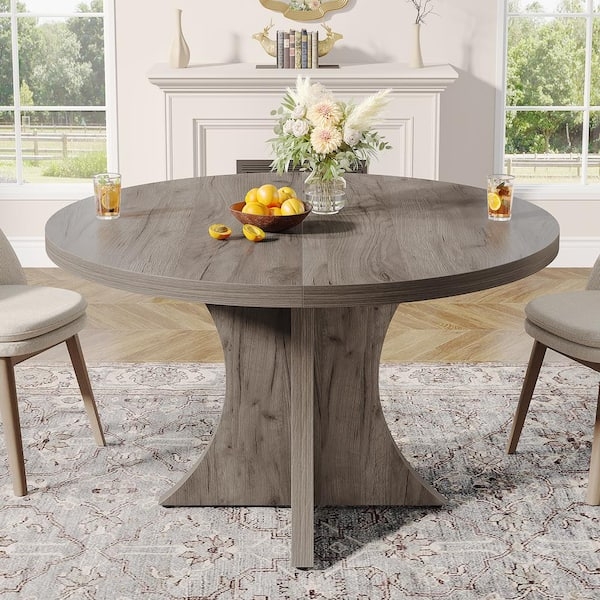 Round Dining Table utilizes Flared Pedestal Base Design