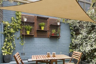 Shade Sail: Blue Brick Backdrop for Small Space Patio Privacy Nook
