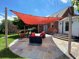 Shade Sail: Burnt Orange Fabric on Flagstone Terrace Lounge Space