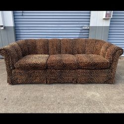 Skirted Leopard Sofa with Scalloped Back and Traditional Skirted Style