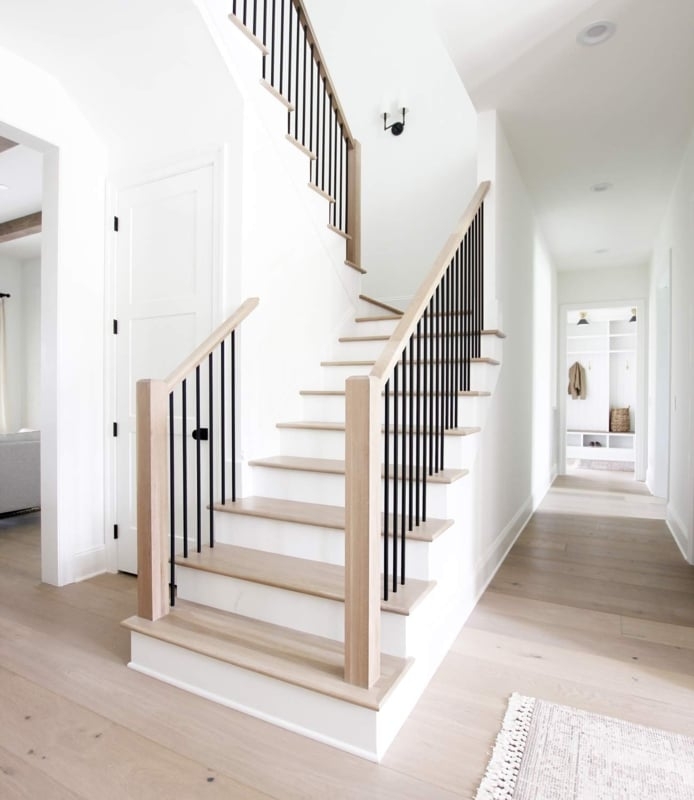 Staircase with black metal spindles for modern staircase lighting