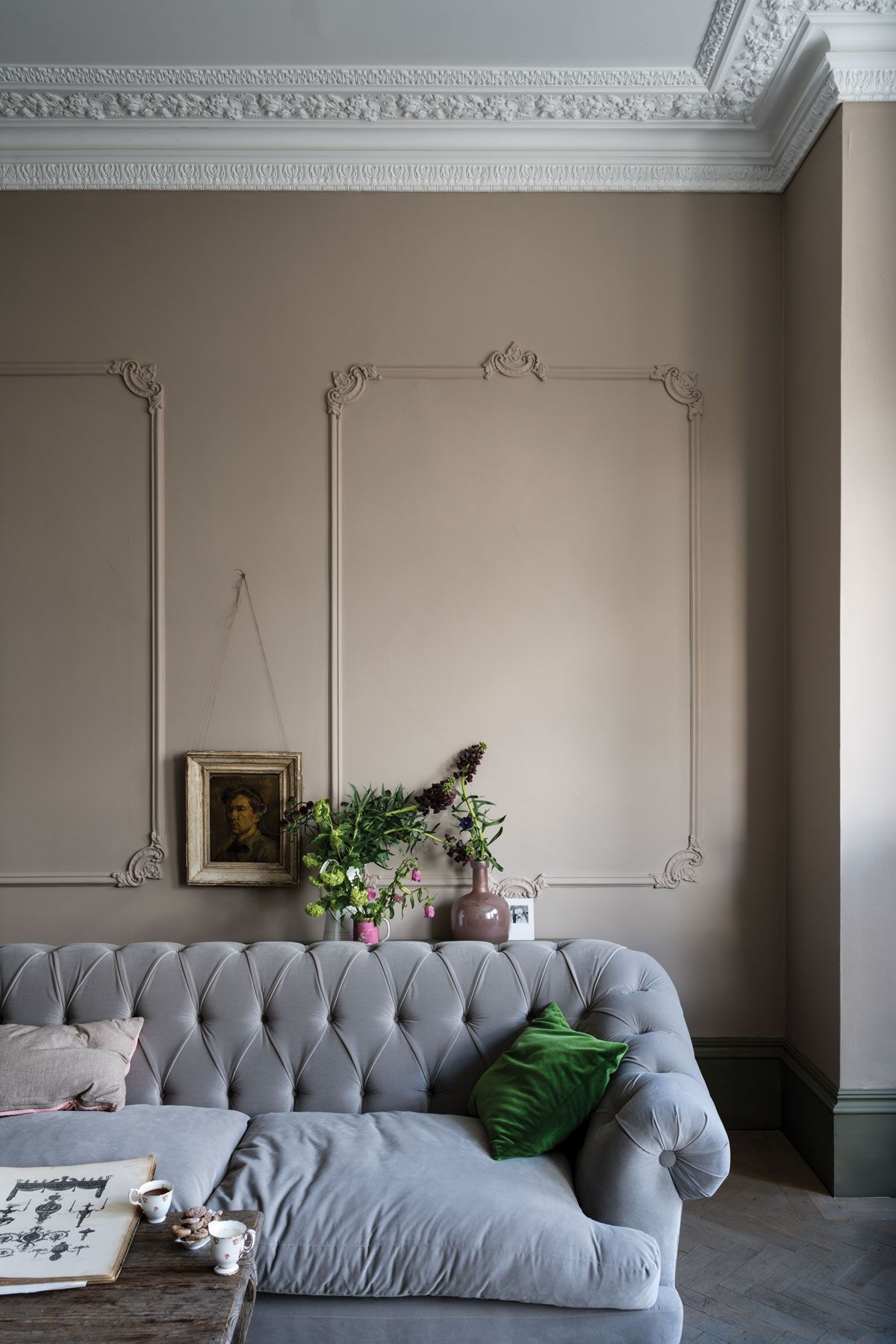 Tufted Sofa with Deep Buttoning and Ornate Wall Molding