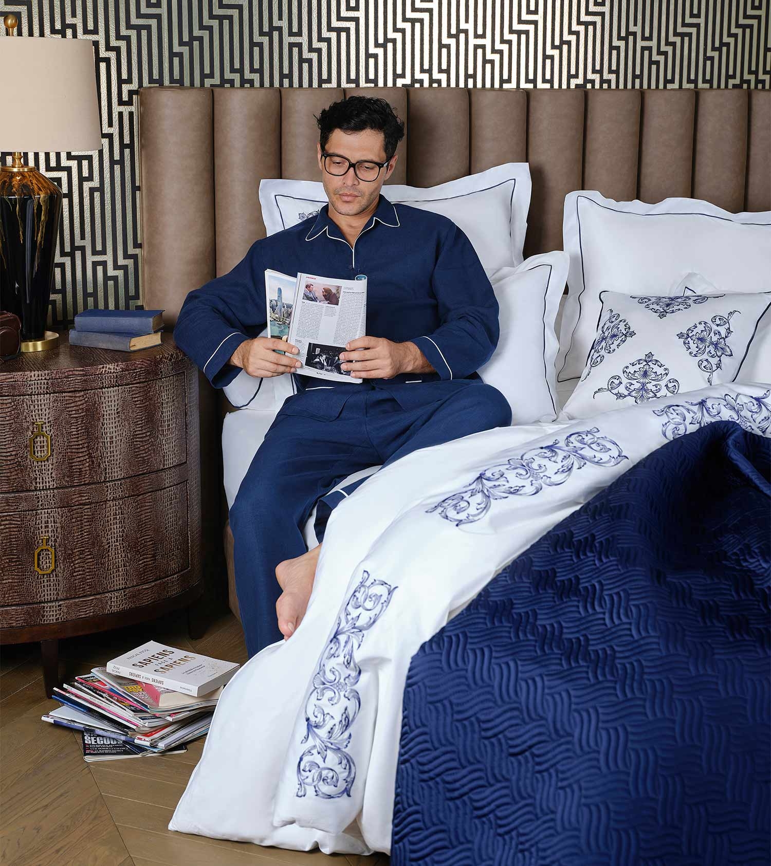 Upholstered Bed: Geometric Wallpaper Accent Wall and Navy Blue