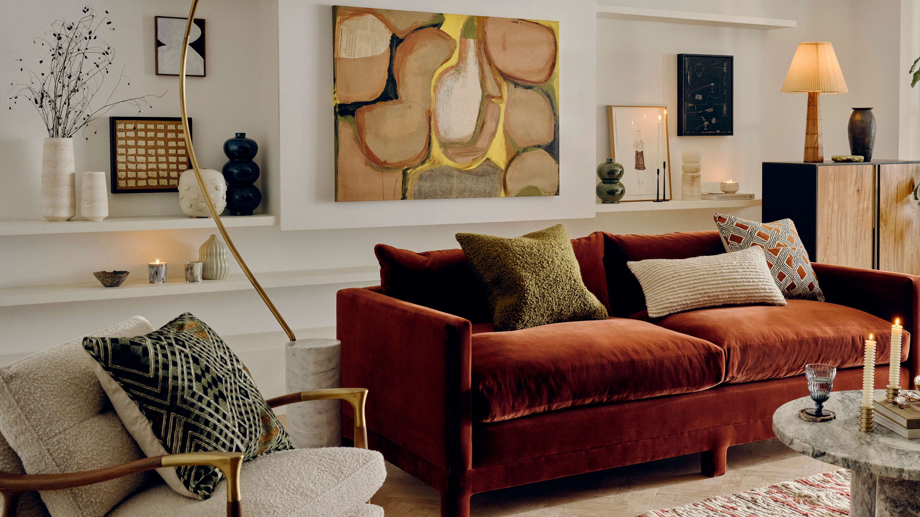 Velvet Sofa near Brass Arched Lamp and Marble Table
