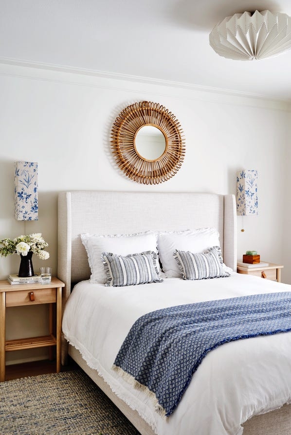 Wingback Bed with Rattan Sunburst Mirror and Blue Botanical Sconces