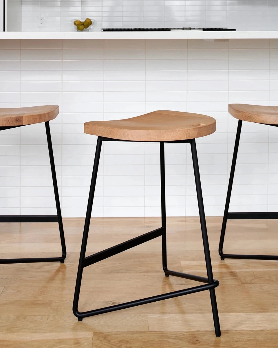 Bar Stool featuring Sculptural Saddle Seat and Steel Base