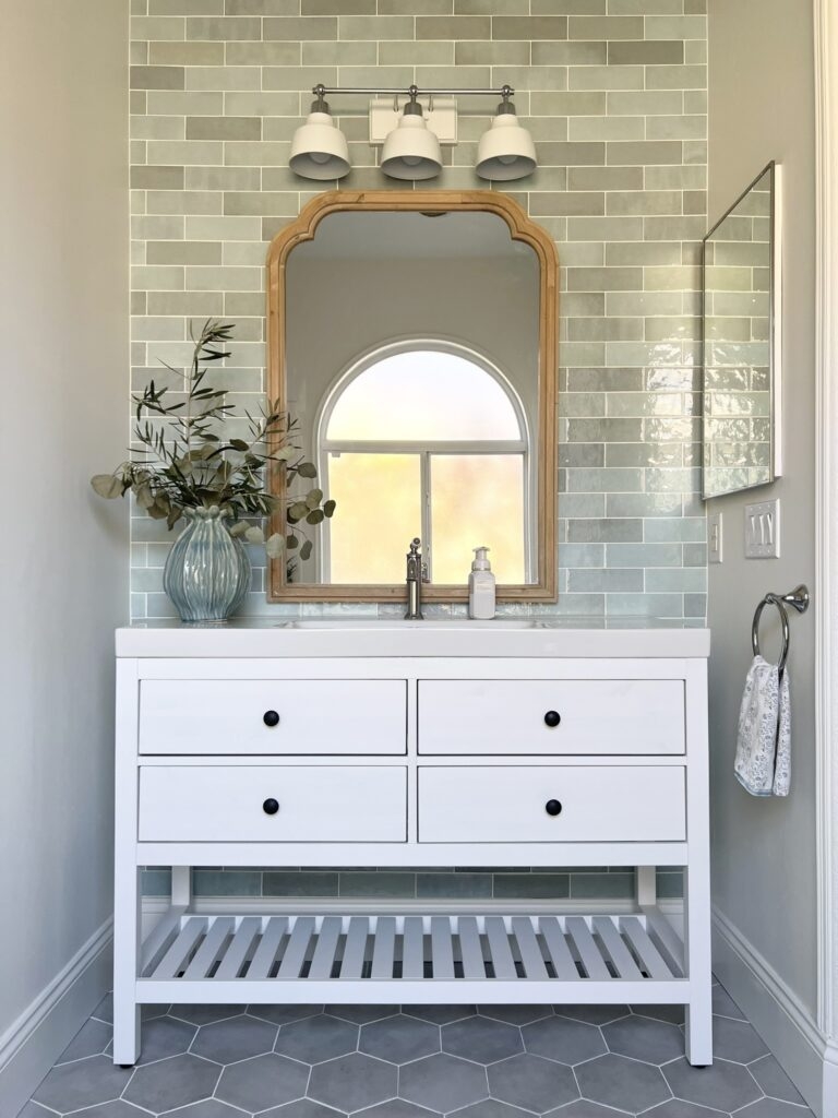 Bathroom Vanity with Sage Green Accent Wall and Arched Frame