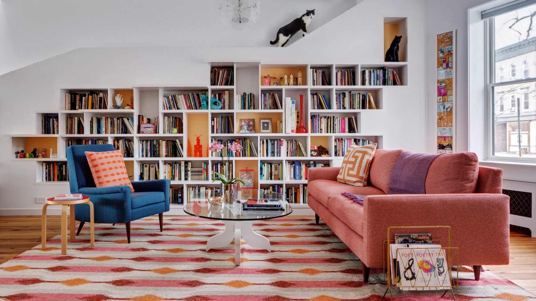 Built In Bookcase: Asymmetric Shelving and Colorful Palette