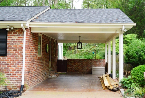 Carport with Central Pendant and Brick Knee Wall Architecture