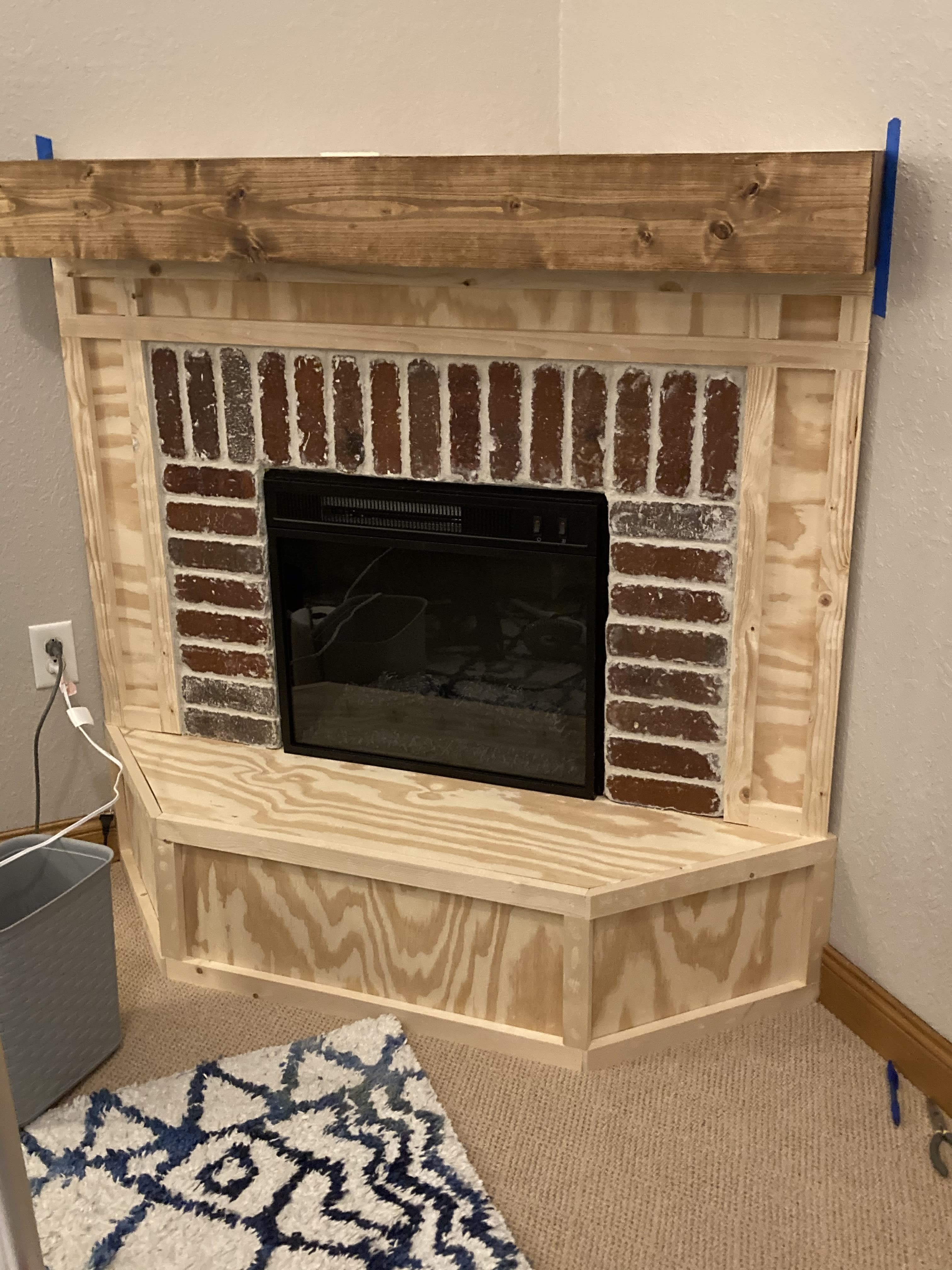 Corner Fireplace DIY Plywood Project with Brick Surround