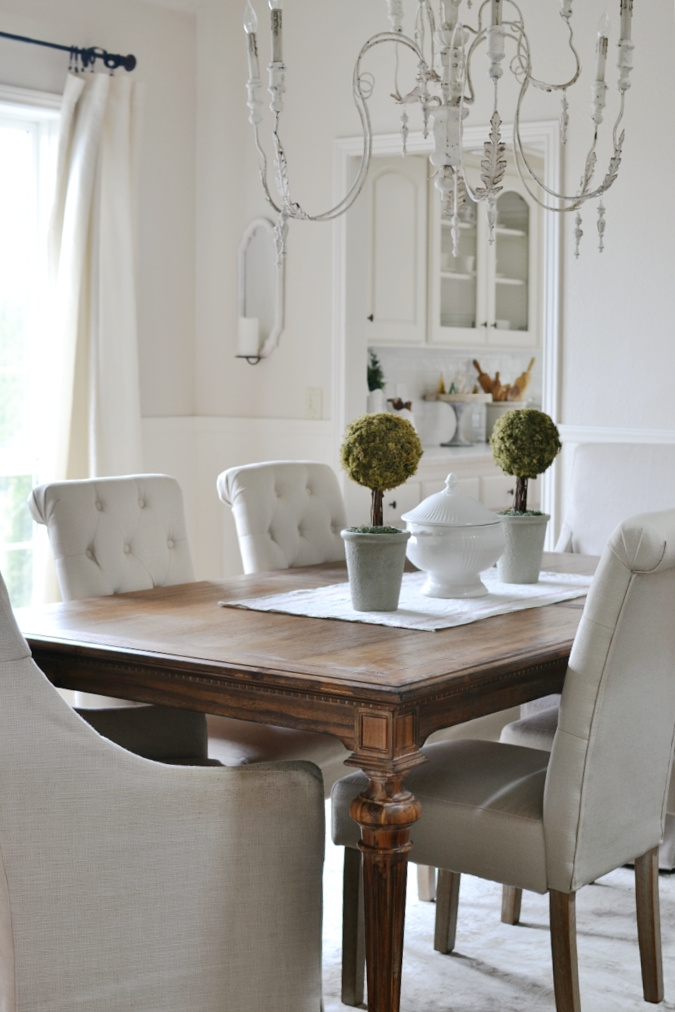 Dining Table with Tufted Back Chairs and Vintage Chandelier